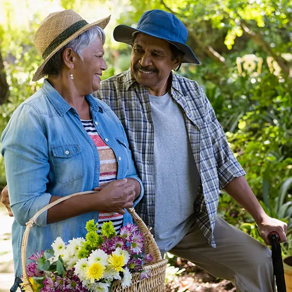 a couple in a garden, the smile happily at each other